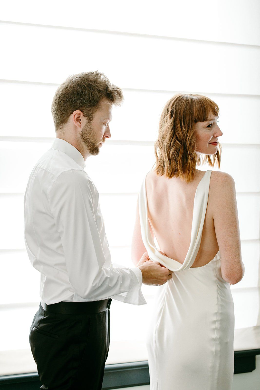 bride and groom get ready for their wedding together