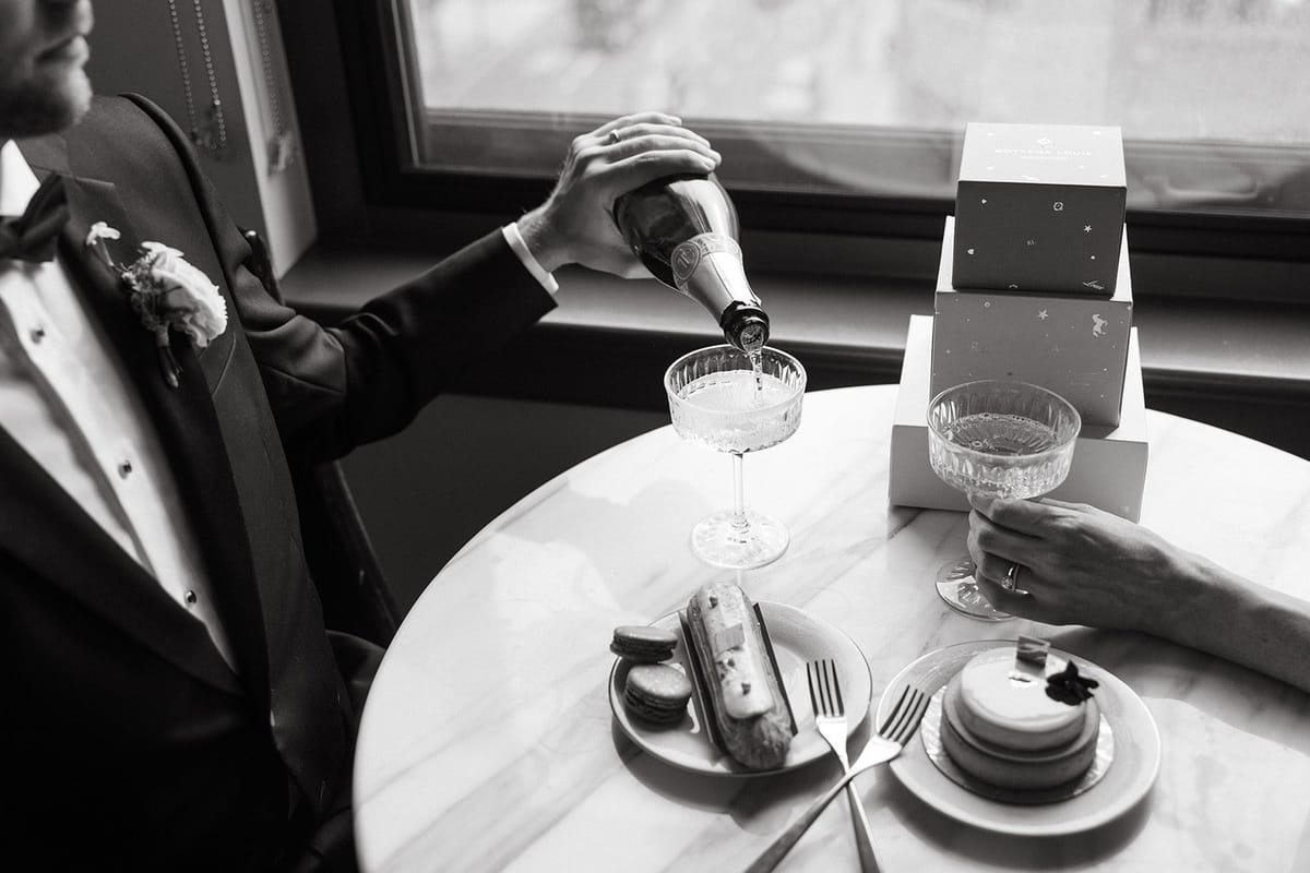 bride and groom share champagne before their elopement in southern california